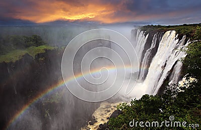 Victoria Falls sunset with rainbow, Zambia Stock Photo