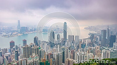 The famous view of Hong Kong from Victoria Peak night to day timelapse. Taken before sunrise with colorful clouds over Stock Photo