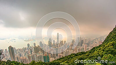 The famous view of Hong Kong from Victoria Peak timelapse. Taken at sunrise with colorful clouds over Kowloon Bay. Stock Photo