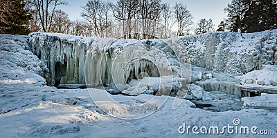 Famous waterfall in Estonia. Keila-Joa Schloss Fall. Partly frozen waterfall by winter. Stock Photo