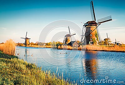 Famous windmills in Kinderdijk museum in Holland. Picturesque outdoor scene of Netherlands, Europe. UNESCO World Heritage Site. Tr Stock Photo