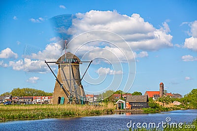 Famous windmills in Kinderdijk village in Holland. Spinning windwill. Colorful spring landscape in Netherlands, Europe. UNESCO Wor Stock Photo