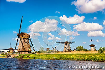 Famous windmills in Kinderdijk village in Holland. Colorful spring rural landscape in Netherlands, Europe. UNESCO World Heritage Stock Photo