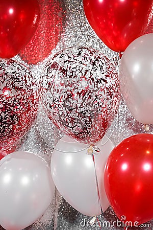 Fancy balloons. Closed up of helium balloons in red and white concept for indoor party celebration or special occasions like Stock Photo