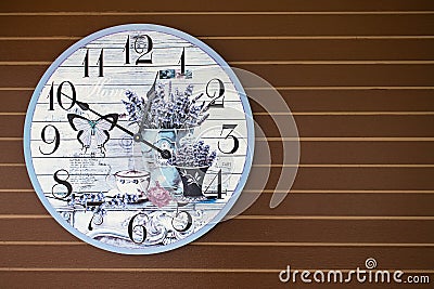 Fancy butterfly and flower clock decorate on wooden wall Stock Photo