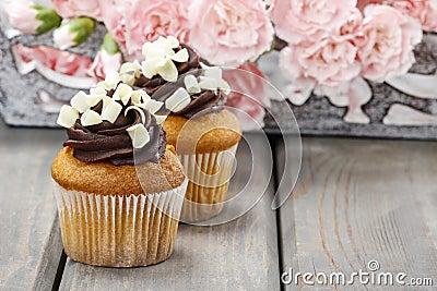 Fancy chocolate cupcakes on wooden table Stock Photo