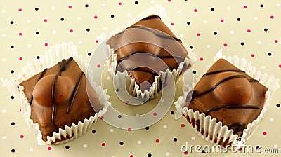 Fancy chocolate iced fondant cakes. Stock Photo