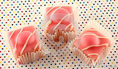 Fancy pink iced fondant cakes. Stock Photo