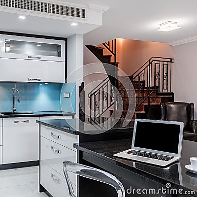 Bright kitchen interior with black worktops Stock Photo