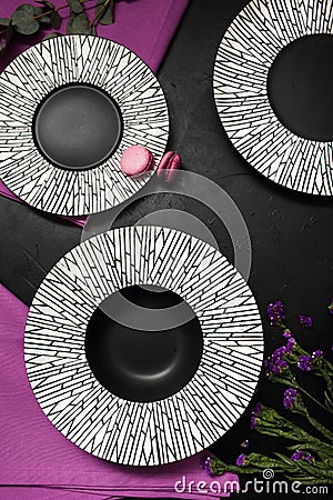 Fancy plates black background restaurant setting Stock Photo