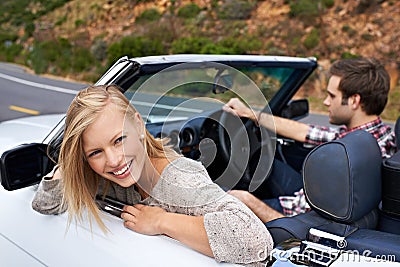 Fancy some adventure. a young couple enjoying a drive in a convertible. Stock Photo