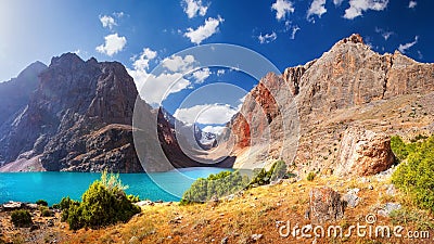 Fann mountains, Tajikistan. Turquoise water in Greater Allo lake in Fan mountains on clear summer day. Amazing bright view on Stock Photo