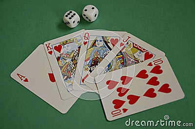 Fanned Out Red Hearts Poker Royal Flush and Dice on Green Baize Stock Photo