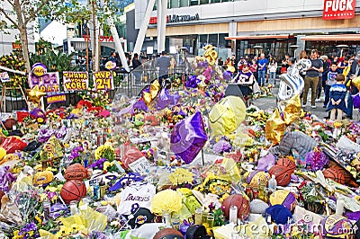 Fans gather at a makeshift memorial in front of Staples Center to honor Kobe Bryant, basketball legend. Editorial Stock Photo