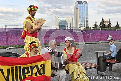 Fans of the Spanish national team sing along with the accordionist from Ukraine before the semifinal match of EURO 2012 in Donetsk Editorial Stock Photo