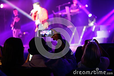Fans take pictures with their mobile phones during David Bustamante live in mallorca Editorial Stock Photo