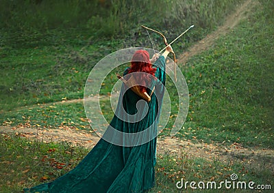 Fantastic character, bright photo, the best woman shooter bravely and courageously goes hunting, red-haired girl is Stock Photo