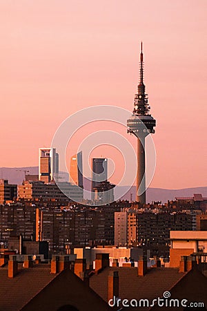Fantastic cityscape of Madrid with sunlit modern high-rise buildings and TV tower at twilight Editorial Stock Photo
