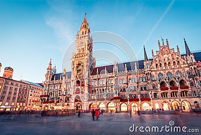 Fantastic evening view of Marienplatz - City-center square & transport hub with towering St. Peter`s church, two town halls and a Editorial Stock Photo