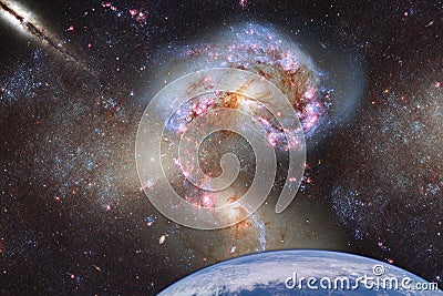 Fantastic landscape of space with a planet on a background of galaxies with a reflection of the rays of the sun. Elements of this Stock Photo