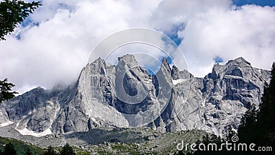 Fantastic mountain landscape in the Swiss Alps with jagged sharp granite peaks under a cloudy sky Stock Photo