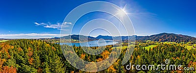 Fantastic panoramic view over the bavarian lake Tegernsee in autumn with fall colors, made by a drone. Stock Photo