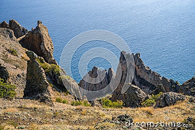 Fantastic stone pillars in the Karadag reserve, Crimea. View from the top of mountain in sanny day of golden autumn Stock Photo