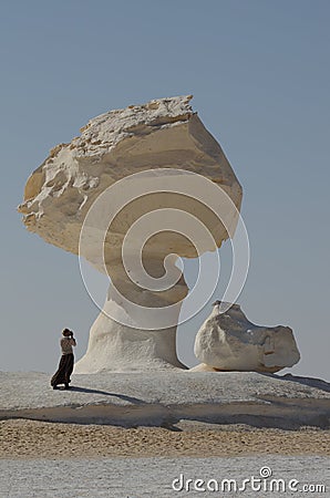 Fantastic stones of the White Desert, Egypt. Tourists take pictures of stones. Editorial Stock Photo