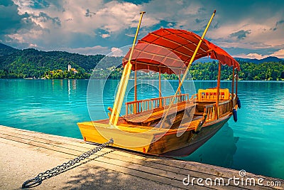 Wooden Pletna boat on the lake Bled with small island Stock Photo