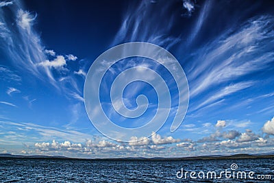 Fantastic vague white clouds against a dark blue sky float Stock Photo