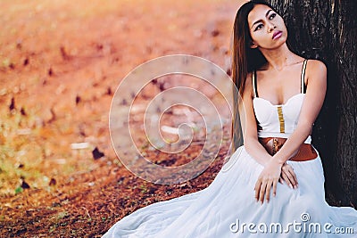 Fantastic young woman. beautiful fantasy girl fairy with white long dress in windy autumn park Stock Photo