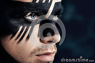 Fantasy art makeup. man with black painted mask on face. Close up Portrait. Professional Fashion Makeup. Stock Photo