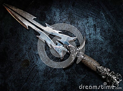 Fantasy dark blade over grunge blue background Stock Photo