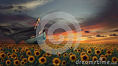 Fantasy portrait of young woman in black dress on the boat Stock Photo