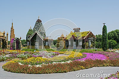 Fantasy village with houses and castles near the colorful flowerbeds Editorial Stock Photo