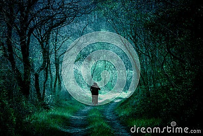 Fantasy woods, people silhouettes on a forest path Stock Photo