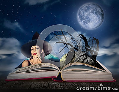 Fantasy world. Open book of fairytales with witch and black crow on pages Stock Photo