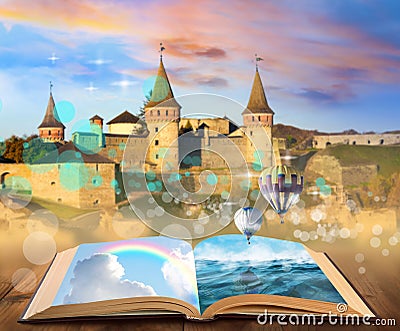 Fantasy worlds in fairytales. Book, hot air balloons and enchanted castle on background Stock Photo