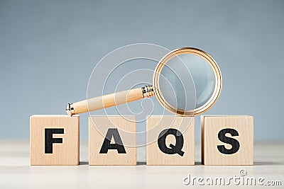 FAQS with magnifying glass Stock Photo