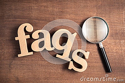 FAQs with Magnifying Glass Stock Photo