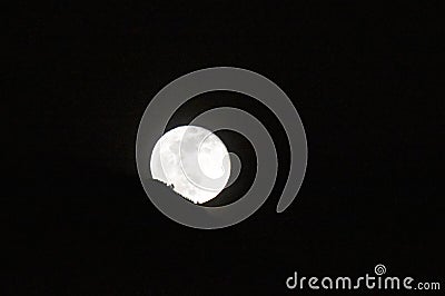 A moon, giving landscape a silver hue at night. Stock Photo