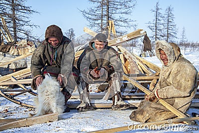 Far north of Yamal, tundra, pasture nord reindeers, family of reindeer herders of the north, father with two sons and a dog Stock Photo