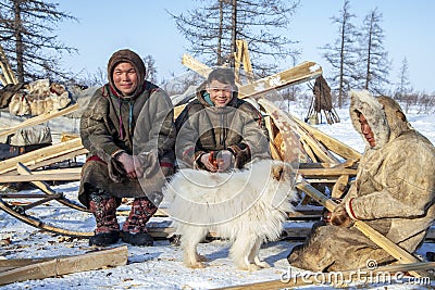 Far north of Yamal, tundra, pasture nord reindeers, family of reindeer herders of the north, father with two sons and a dog Stock Photo