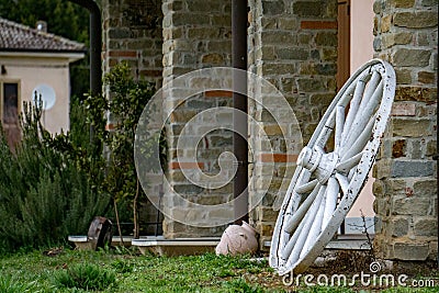 Far west wagon wheel on stone wall Stock Photo