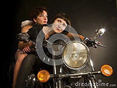 Faraway look biker girl with guardian angel Stock Photo