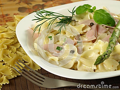 Farfalle pasta with ham Stock Photo