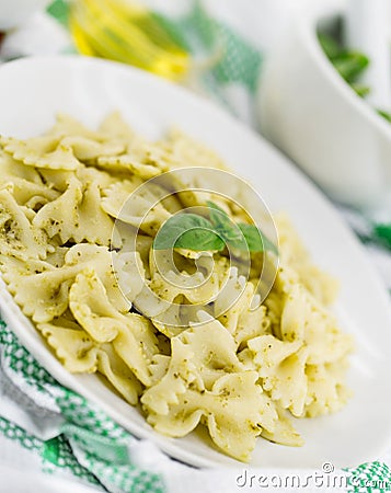 Farfalle pasta with pesto genovese basil sauce on white rusti Stock Photo
