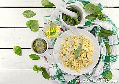 Farfalle pasta with pesto genovese & x28;basil sauce& x29; on white rusti Stock Photo