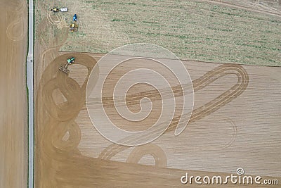 Farm tractor preparing and planting field Editorial Stock Photo