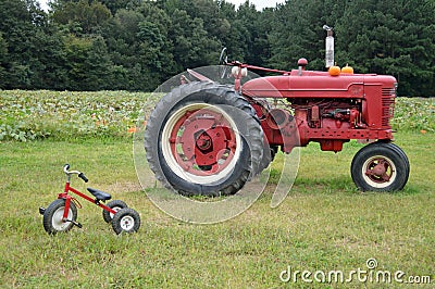 Farm tractor and tricycle Stock Photo
